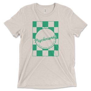 A sand colored t-shirt with a green checkered Psychocandy logo in the center of it.